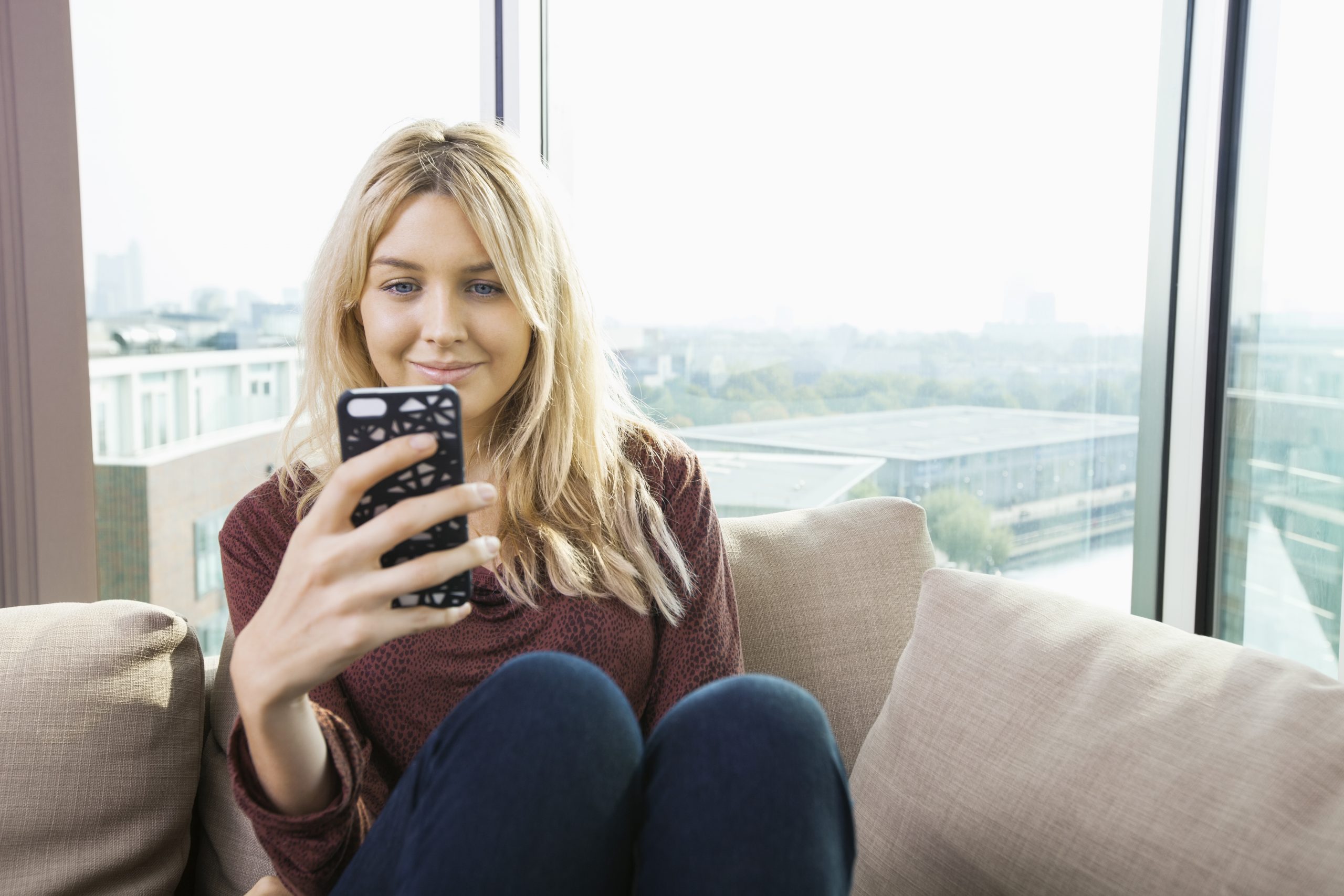 woman on couch on phone